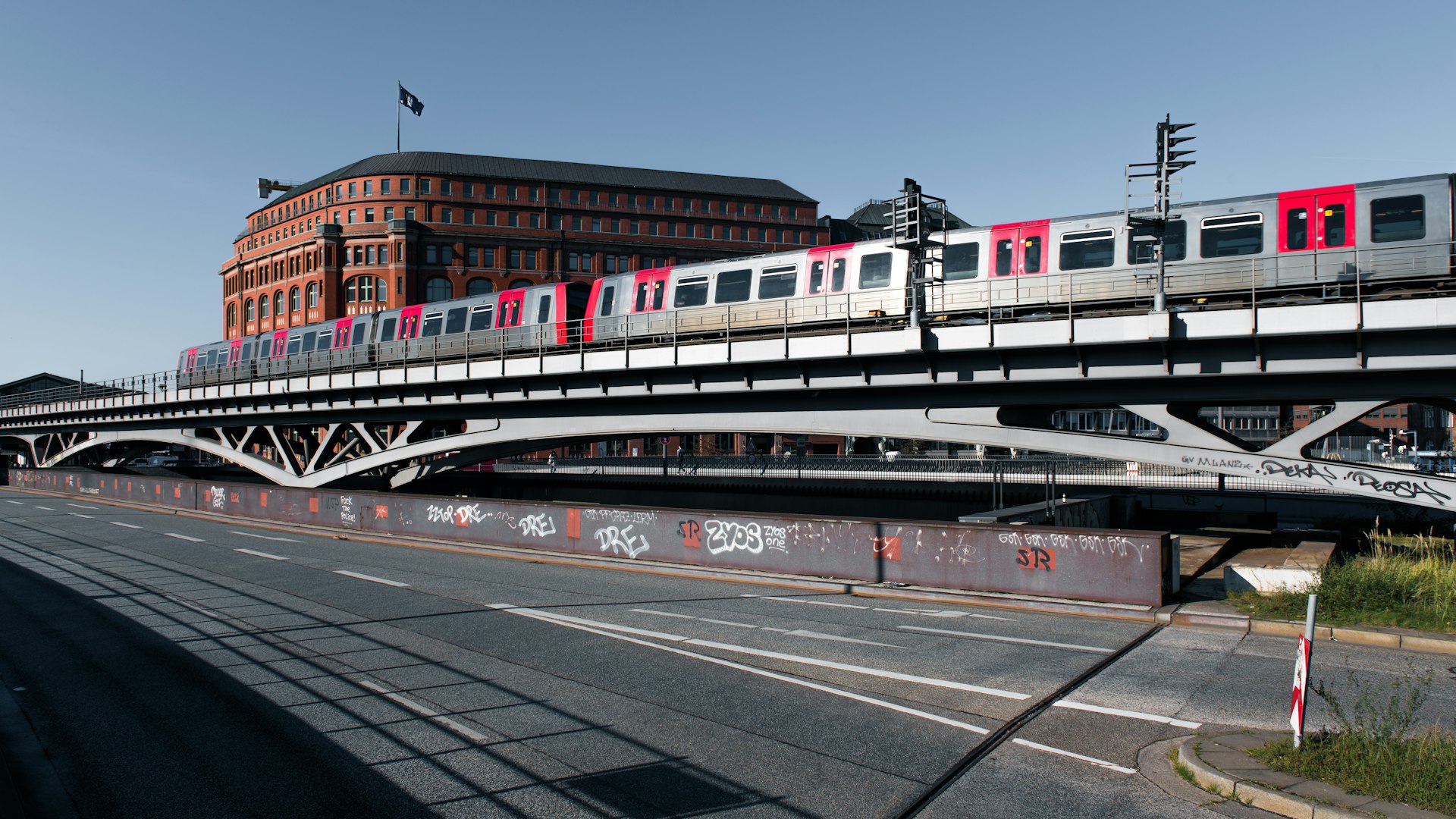 A train traveling across a bridge over a street